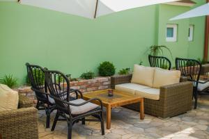 a patio with chairs and a table and a couch at Penzión Kúria in Nové Mesto nad Váhom