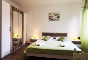 a bedroom with a bed with two towels on it at Apartments Jelena in Pag