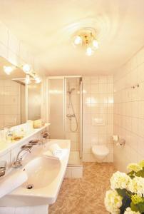 a bathroom with a sink and a shower and a toilet at Pezinerblick in Ischgl
