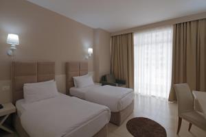 Postel nebo postele na pokoji v ubytování Horizont Hotel