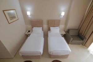 Postel nebo postele na pokoji v ubytování Horizont Hotel