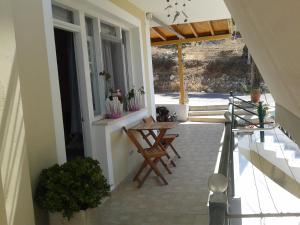 an outdoor patio with two chairs and a table at South Side in Athani