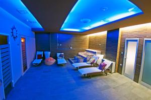 a waiting room with blue lights and couches and chairs at Grand Hotel Park in Dubrovnik