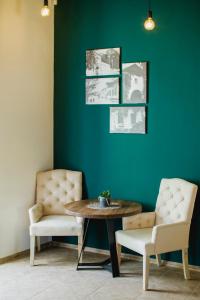 a dining room with a table and two chairs at Penzión Kúria in Nové Mesto nad Váhom