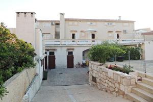 a view of a building from the street at Apartments Jelena in Pag