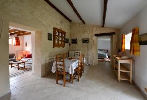 a kitchen with a table and chairs in a room at Gites dans les Champs in Sauzé-Vaussais