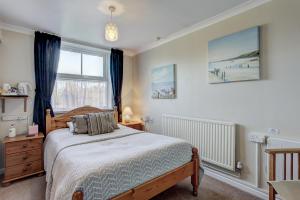 A bed or beds in a room at South Norfolk Guest House 
