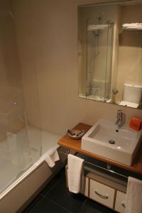 a bathroom with a sink and a shower and a tub at Apartaments Independencia in Barcelona +46 photos