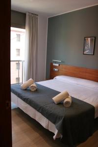 a bedroom with two beds and a large window at Apartaments Independencia in Barcelona