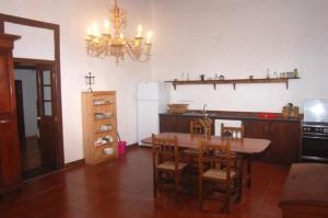 a kitchen with a table and chairs and a chandelier at GBH Casas Las Portadas in La Oliva