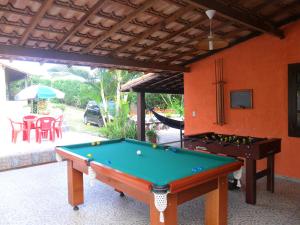 a pool table in front of a house at Pousada Viva Mar in Saquarema