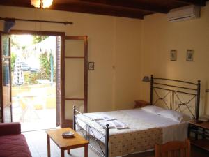 a bedroom with a bed and a living room at Alexandros Studios & Apartments in Chania Town