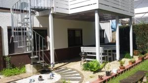a screened in porch with a bench on a patio at Haus Waldesruh in Igel