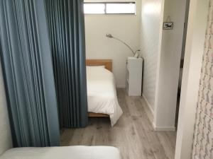 Postel nebo postele na pokoji v ubytování Guesthouse ORI ORI