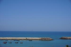 a large body of water with a blue sky at Hotel Zelis in Asilah