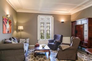 a living room with couches and chairs and a table at Bcn Paseo De Gracia Rocamora Apartment in Barcelona