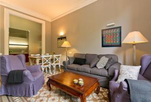 a living room with couches and a coffee table at Bcn Paseo De Gracia Rocamora Apartment in Barcelona