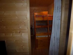 a room with two bunk beds and a curtain at Joly Bois in Crest-Voland
