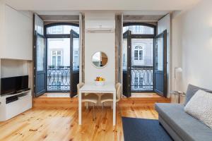 a living room with a table and a couch at BO - Almada in Porto