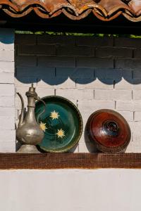 two bowls and a vase sitting on a shelf at Zoev House in Karlovo +193 photos