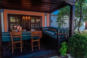 a patio with a table and chairs on a porch at Zoev House in Karlovo