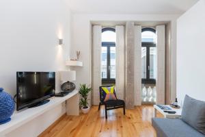 a living room filled with furniture and a tv at BO - Bolhão Apartments in Porto