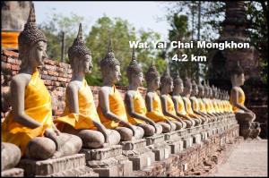 a row of statues sitting on a wall at Early Bird Hostel Ayutthaya in Phra Nakhon Si Ayutthaya