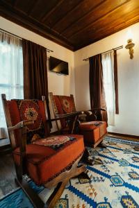 a living room with two chairs and a rug at Zoev House in Karlovo