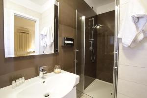 a bathroom with a shower and a sink and a mirror at Garden Hotel Ripa in Vieste
