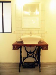 a bathroom with a sink and a mirror at La Gauviniere in Liez