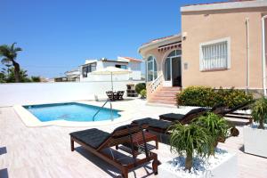 a villa with a swimming pool and a house at Casa Bruno in Ciudad Quesada