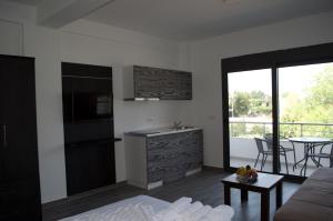 a kitchen and living room with a couch and a table at Flo Apartments in Ulcinj