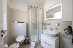 a bathroom with a toilet and a sink and a shower at Ferienhaus Küstensegler in Breege