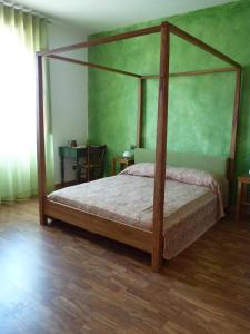 a bedroom with a canopy bed in a room at Casabettina in Valderice
