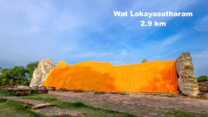 a large orange blanket sitting on the ground at Early Bird Hostel Ayutthaya in Phra Nakhon Si Ayutthaya