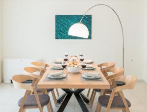 uma mesa de jantar com cadeiras e uma luz pendente em Spring Apartments em Chania