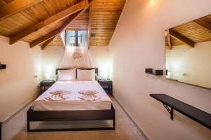 a bedroom with a bed with pink towels on it at Villa Kanonia Gerakas in Vasilikos +43 photos