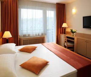 Postel nebo postele na pokoji v ubytování Garni Hotel Savica - Sava Hotels & Resorts
