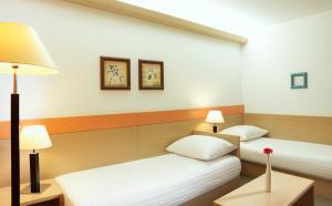 Postel nebo postele na pokoji v ubytování Garni Hotel Savica - Sava Hotels & Resorts