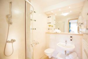 a bathroom with a toilet and a sink and a shower at Garni Hotel Savica - Sava Hotels & Resorts in Bled