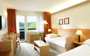 Postel nebo postele na pokoji v ubytování Garni Hotel Savica - Sava Hotels & Resorts