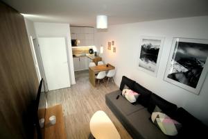 a living room with a couch and a table at Apartamenty Podgorze in Szklarska Poręba