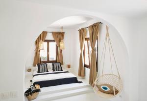 a bedroom with a bed and a swing at Le Blanc Suite in Mesaria
