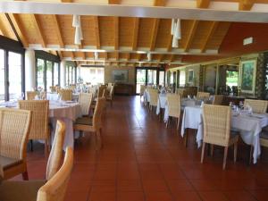 a dining room with white tables and chairs at Hotel Del Parco Ristorante Loris in Pieve di Soligo +16 photos