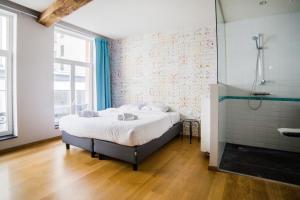 1 dormitorio con cama grande y ducha en Smartflats - Monnaie en Bruselas