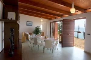 a dining room with a white table and chairs at Casa Paradiso - Panoramic Sea View & Jacuzzi in Terracina