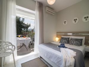
a hotel room with a large bed and a large window at Frau Irenes Haus in Sarti
