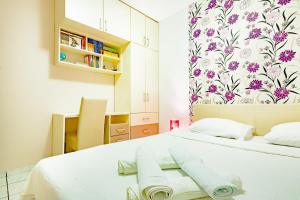 a bedroom with a white bed with towels on it at Apartments Adriatic in Sveti Stefan