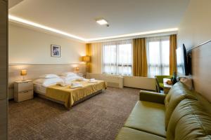Postel nebo postele na pokoji v ubytování Hotel Kamilla