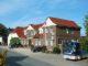 a large brick building with a street in front of it at Neukirchener Hof in Malente